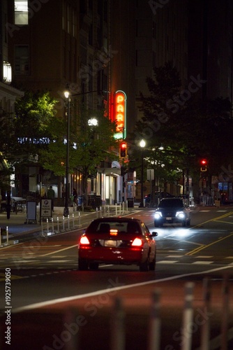 Wallpaper Mural car driving by a parking garage with a parking sign lighting up behind it Torontodigital.ca
