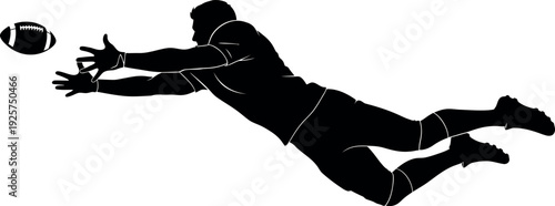 Silhouette of a soccer goalkeeper diving to catch the ball