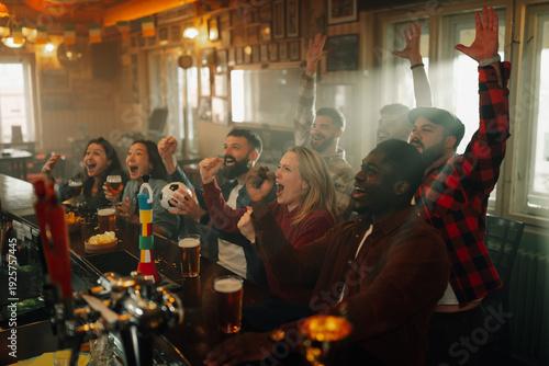 Wallpaper Mural Diverse friends cheering loudly watching sports in pub Torontodigital.ca