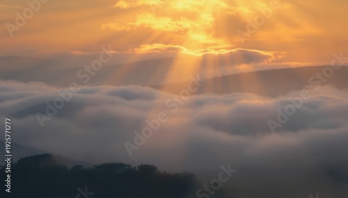 Golden sunrise over clouds and mountains