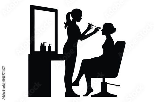 Makeup artist applying makeup to client in salon