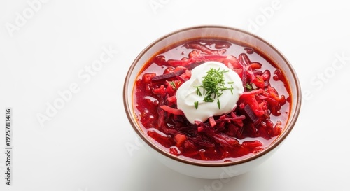 Traditional ukrainian borscht with sour cream and fresh herbs in a ceramic bowl