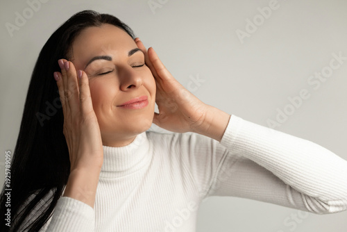 Fotografie Peaceful Woman Enjoying Relaxation With Eyes Closed