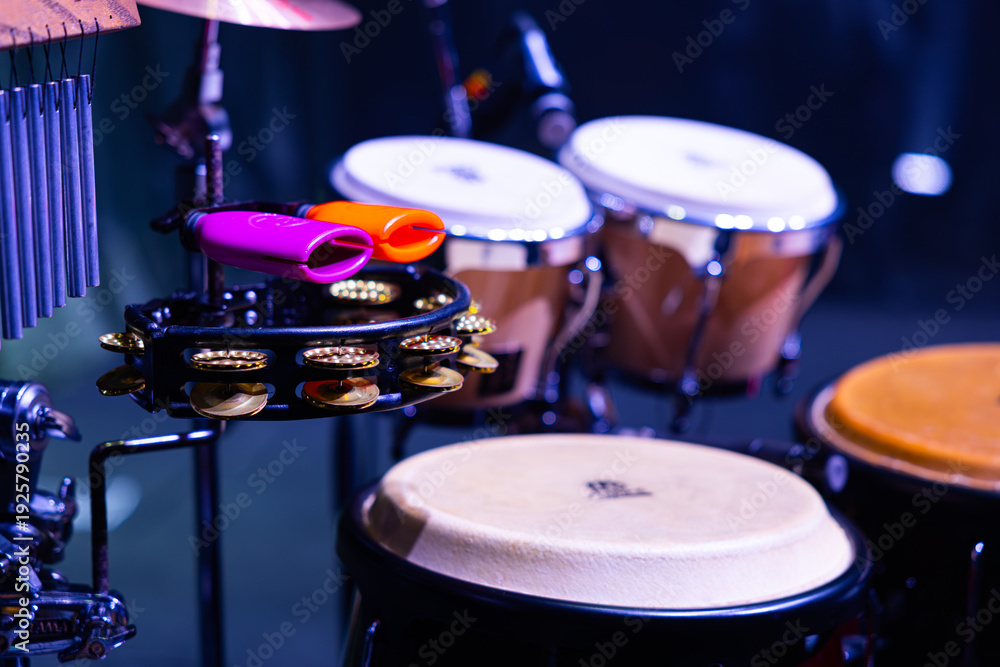 Fototapeta premium Percussion Setup with Meinl Cowbells, Tambourine, and LP Congas on Stage