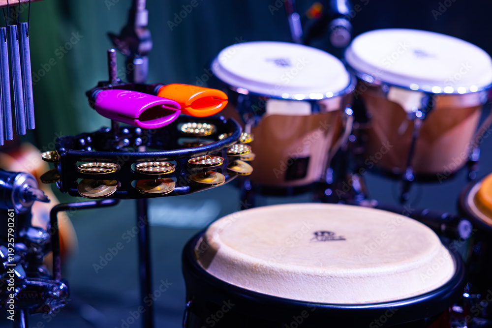 Obraz premium Percussion Setup with Meinl Cowbells, Tambourine, and LP Congas on Stage