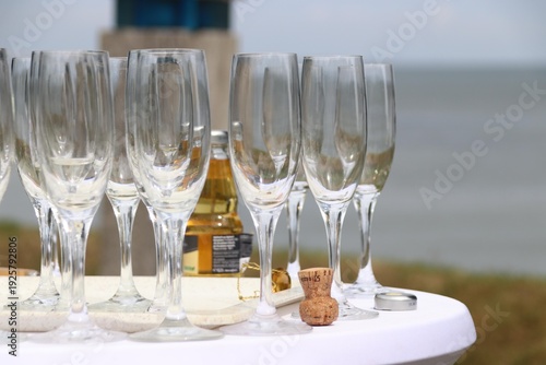 Glasses and sparkling wine on a white standing table on the beach create a festive atmosphere, Sylt, Keitum