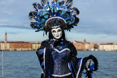 Fotografija Venice, Italy - February 09, 2026: Elegant masked figure in blue costume with el