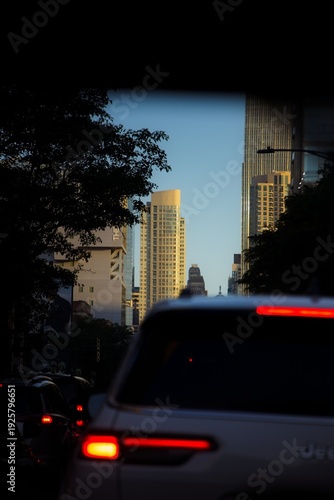 Wallpaper Mural View of a Car Driving Down a Chicago Street at Sunrise with Tall Buildings Surrounding it Torontodigital.ca