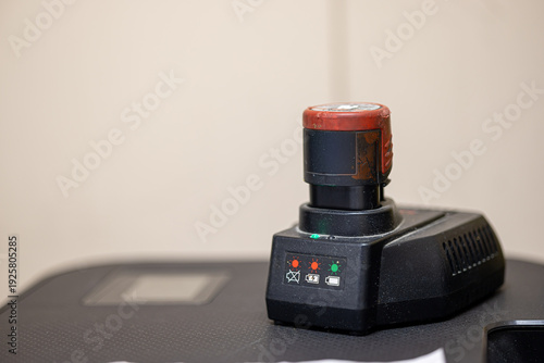 Fotografie Lithium ion battery pack charging on professional charger station for cordless p
