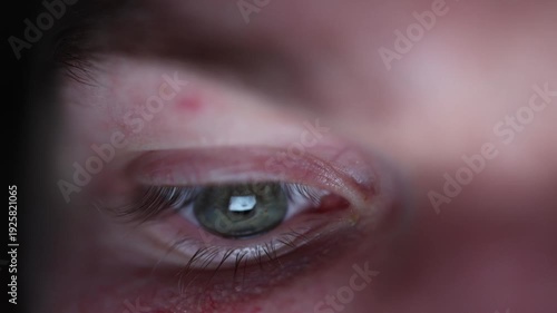 Extreme close up of tired eye lit by screen glow late night phone use digital addiction insomnia concept fatigue and blue light strain