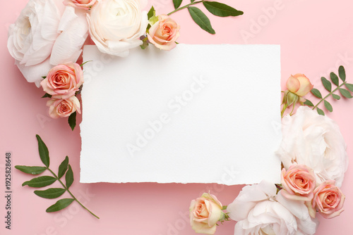 Beautiful ranunculuses, roses and blank card on pink background, flat lay. Mockup for design