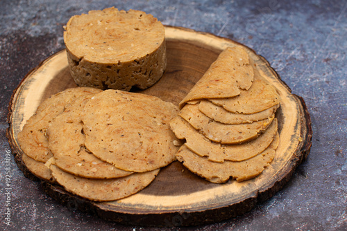 Plant based vital wheat gluten seitan as meat alternative. Sliced, on wooden board