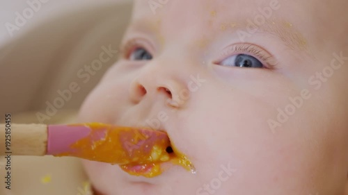 Wallpaper Mural Close up of a baby being fed with a spoon, showing facial details and soft expressions Torontodigital.ca