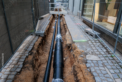 Obraz na plátně City Street Construction With Exposed Pipeline and Trenches Passing Through Urba