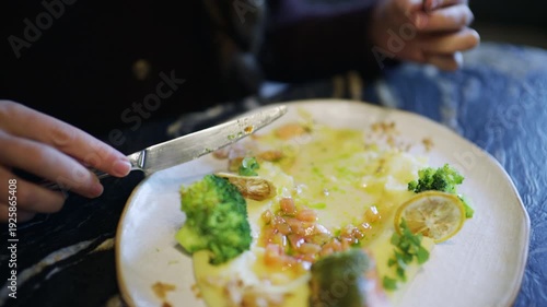Wallpaper Mural Close up of a fork lifting broccoli from a plate with salmon and vegetables Torontodigital.ca