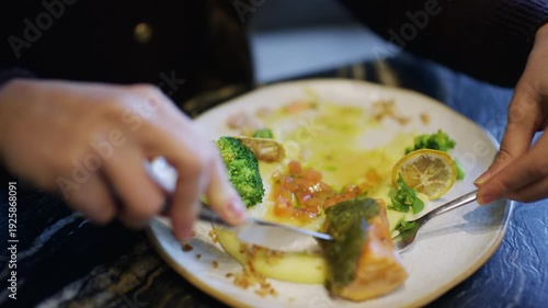 Wallpaper Mural Close up of a fork lifting broccoli from a plate with salmon and vegetables Torontodigital.ca