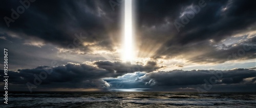 Divine lightbeam descends through dark clouds upon ocean waves at sunset or sunrise, representing creation concept of day two splitting sky water. Banner with copy space