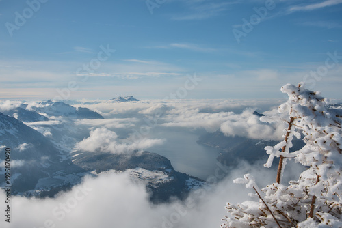 Frozen alpine lake surrounded by snow covered mountains, Stoos Switzerland