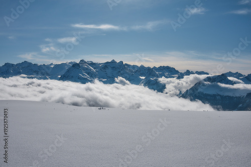 Snowy alpine peaks above sea of clouds, Stoos Switzerland