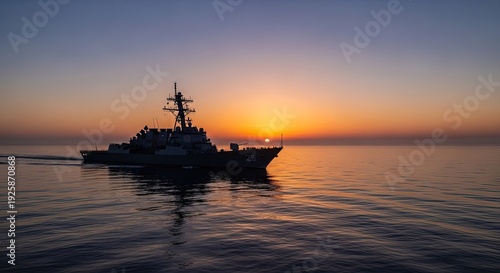 navy ship sailing at sunset