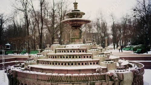 Wallpaper Mural Static shot of a decorative stone fountain covered in snow inside a public park Torontodigital.ca