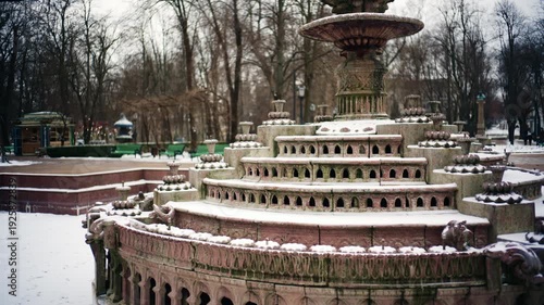 Wallpaper Mural Static shot of a decorative stone fountain covered in snow inside a public park Torontodigital.ca