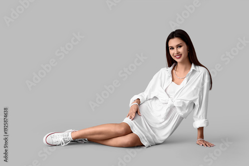Stylish young woman in whit...
