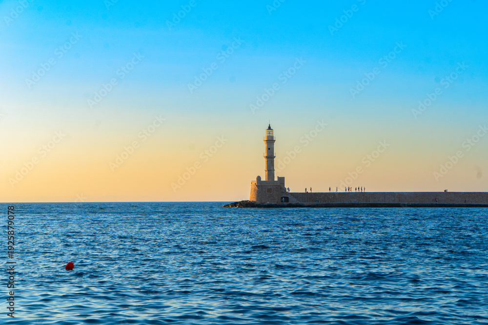 Fototapeta premium bay of Chania with sea and lighthouse at sunny summer sunset, Crete, Greece, web banner format