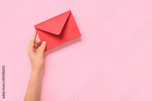 Female hand with red envelo...