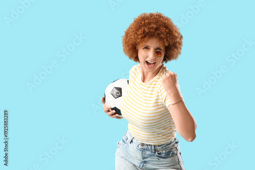 Young female soccer fan wit...