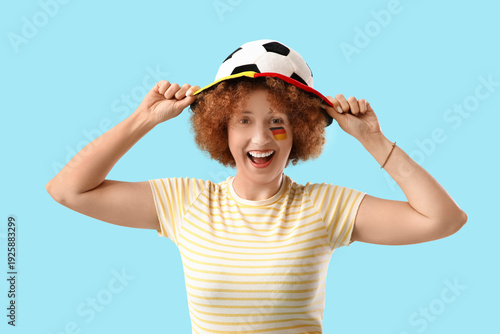 Young female soccer fan wit...