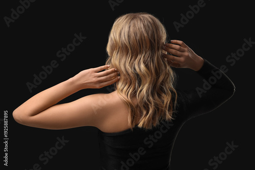 Blonde young woman with cur...