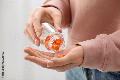 Young woman taking vitamin ...