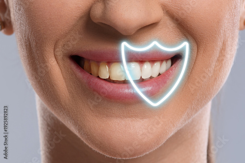 Dental care. Woman with perfect smile on grey background, closeup. Teeth under virtual shield whiter than others