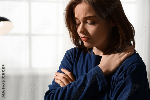 Sad young woman at home, cl...