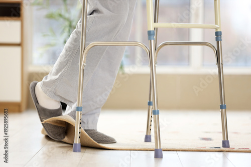 Schilderij op canvas Legs of senior man with walker tripping over carpet at home