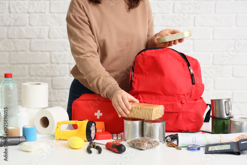 Young woman packing emergen...