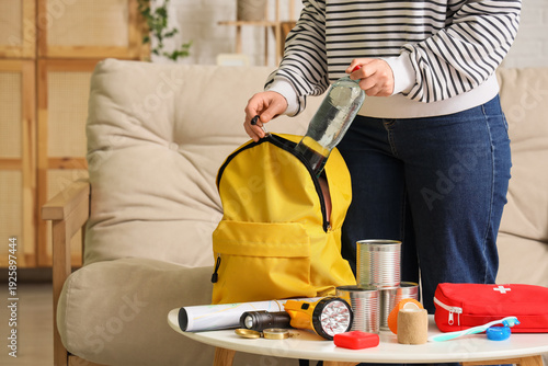 Young woman packing emergen...