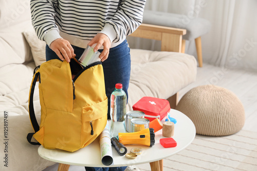 Young woman packing emergen...