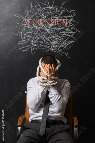 Businessman tied with rope ...
