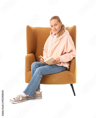 Young woman reading book in...