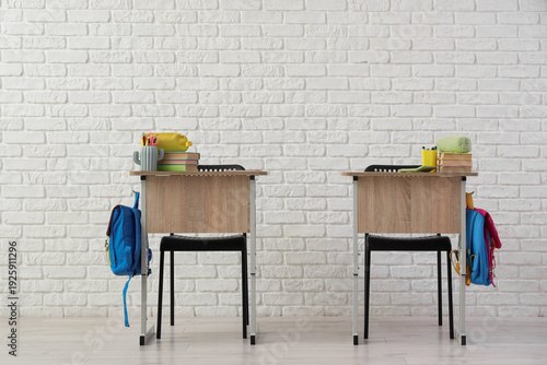 School desks with books and...