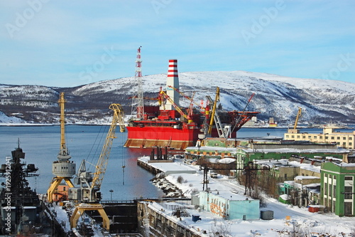 MURMANSK, RUSSIA- November 18, 2011: Self-lifting floating drilling rig PRIRAZLOMNAYA in the port at the pier. The Kola Bay. Barents Sea, Gulf Stream.