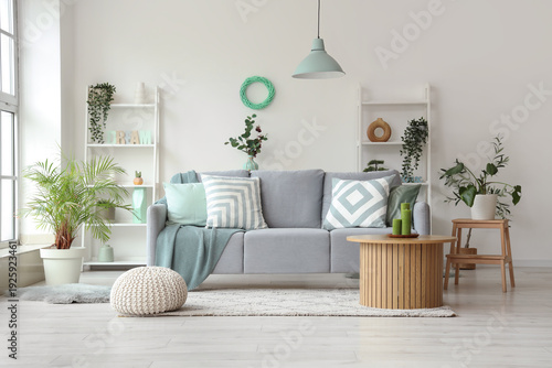 Comfortable sofa and coffee table in interior of living room