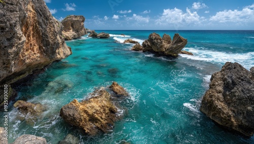 Vibrant Turquoise Tropical Waters and Rugged Coastal Rocks Under Sunny Blue Sky.