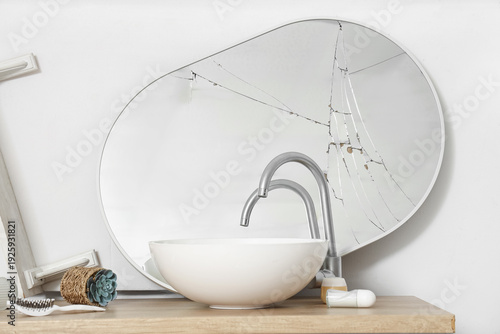 Obraz na plátně Broken mirror with sink on counter in messy bathroom