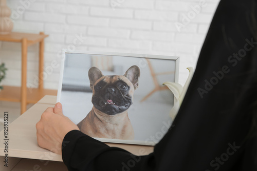Woman holding frame with pi...
