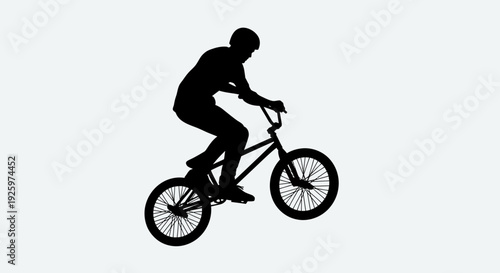 Silhouette of a BMX rider performing a trick on a white background