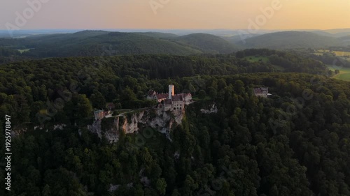 Panoramic drone view of Lichtenstein Castle in southern Germany. Romantic 19th-century architecture, nestled in lush greenery on a mountain ridge. Luftaufnahme Schloss Lichtenstein Wuerttemberg. 