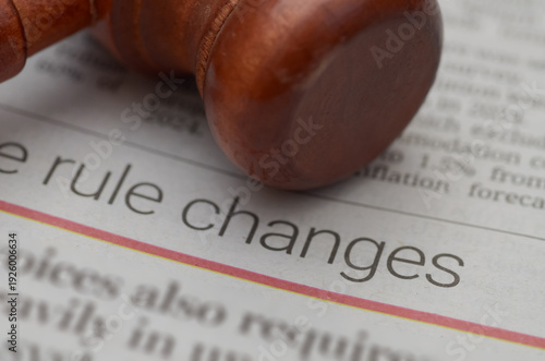 Wooden Gavel Resting on Newspaper Featuring Bold 'Rule Changes' Headline
